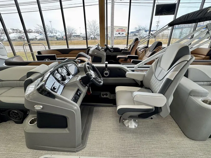Slide: The Image of 2025 Tahoe LTZ 2385 QLS boat interior with modern helm and luxurious seating. - 10