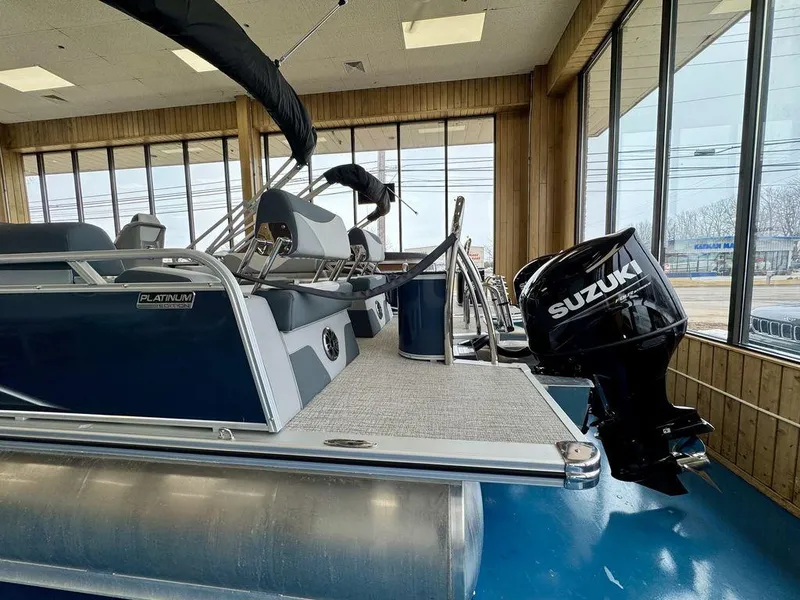Slide: The Image of 2025 Tahoe LTZ 2385 QLS pontoon boat with Suzuki outboard motor in showroom. - 3
