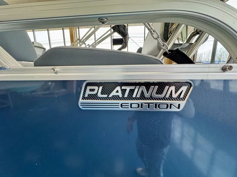 Slide: The Image of 2025 Tahoe LTZ 2385 QLS Platinum Edition boat, blue exterior with logo detail. - 4