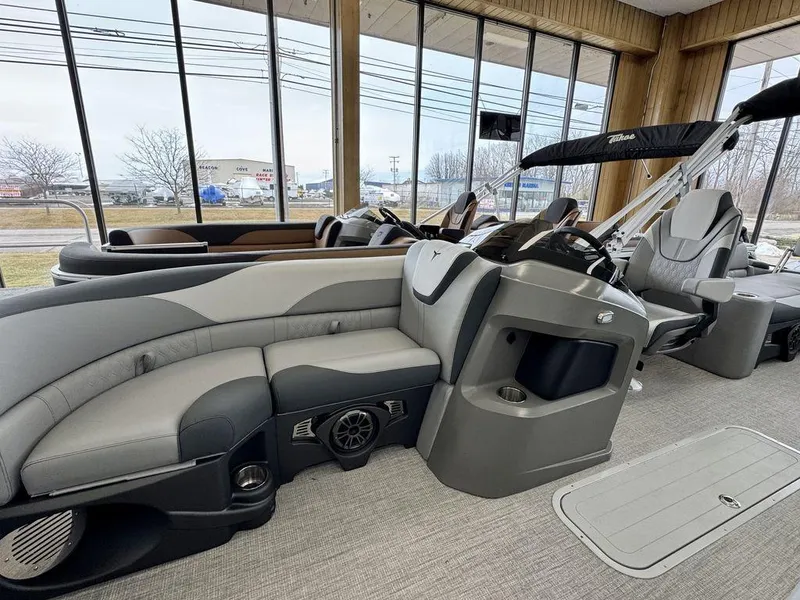 Slide: The Image of 2025 Tahoe LTZ 2385 QLS pontoon boat interior with luxurious seating and modern design. - 7