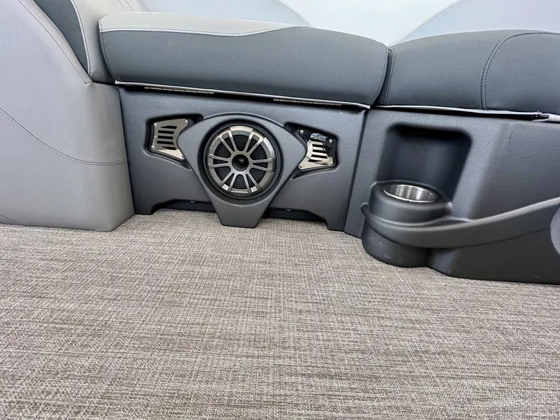 Slide: The Image of 2025 Tahoe LTZ 2385 QLS interior with speaker and cup holder on gray carpet. - 8
