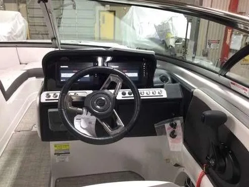 Slide: The Image of 2024 Crownline 250 XSS boat dashboard with steering wheel and control panel. - 2