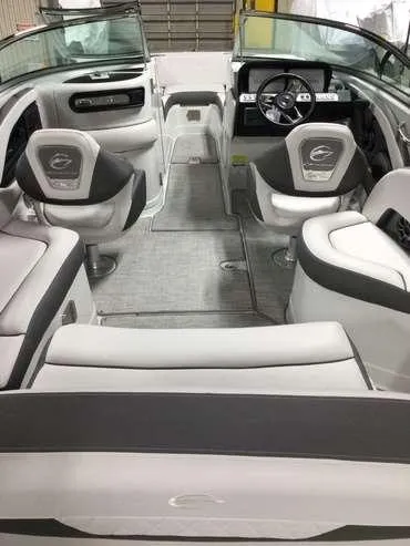 Slide: The Image of 2024 Crownline 250 XSS boat interior with modern seating and steering wheel. - 3