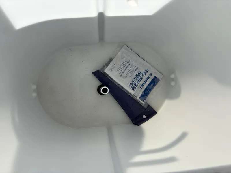 Slide: The Image of Empty storage compartment in a 2025 Custom Maui 16 Fisherman boat. - 12