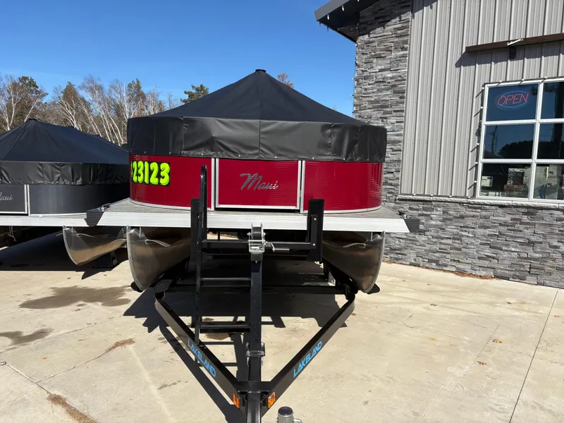 Slide: The Image of Custom Maui 16 Fisherman 2025 boat on trailer, parked near a stone building. - 4