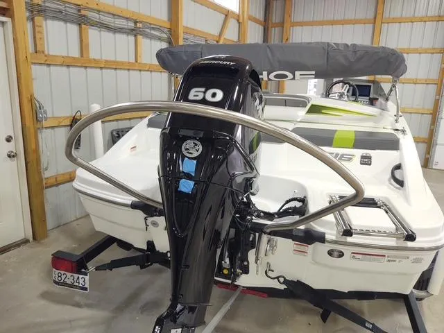 Slide: The Image of 2023 Tahoe T16 boat with 60 HP engine in a garage setting. - 5