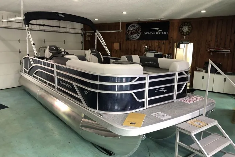 The Image of 2026 Bennington S Swingback 22 SSB SPS pontoon boat in a showroom setting. - 2
