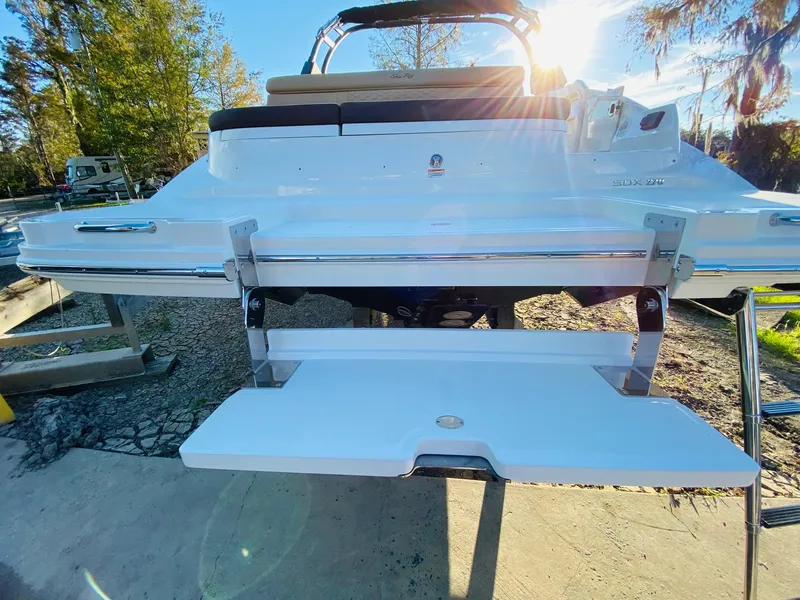 Slide: The Image of 2022 Sea Ray 270 SDX boat with extended swim platform in sunlight. - 10