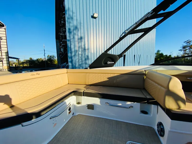 Slide: The Image of 2022 Sea Ray 270 SDX boat interior with beige seating and modern design. - 15