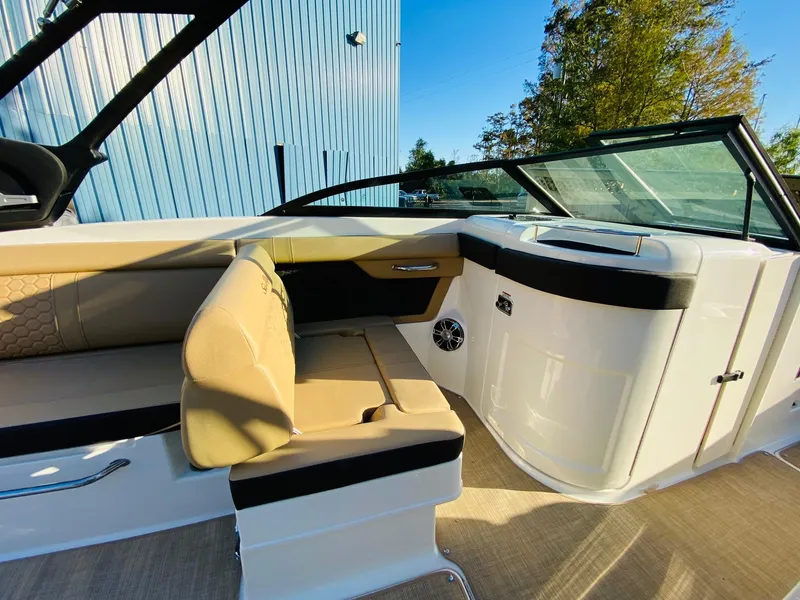 Slide: The Image of 2022 Sea Ray 270 SDX boat interior with beige seating and sleek design. - 16