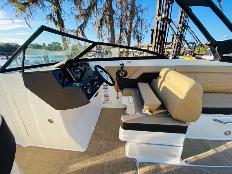 Slide: The Image of 2022 Sea Ray 270 SDX boat interior with helm, seating, and modern dashboard. - 17