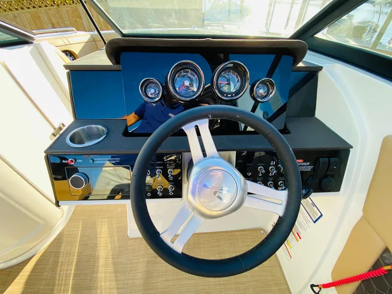 Slide: The Image of 2022 Sea Ray 270 SDX dashboard with steering wheel and instrument panel. - 18