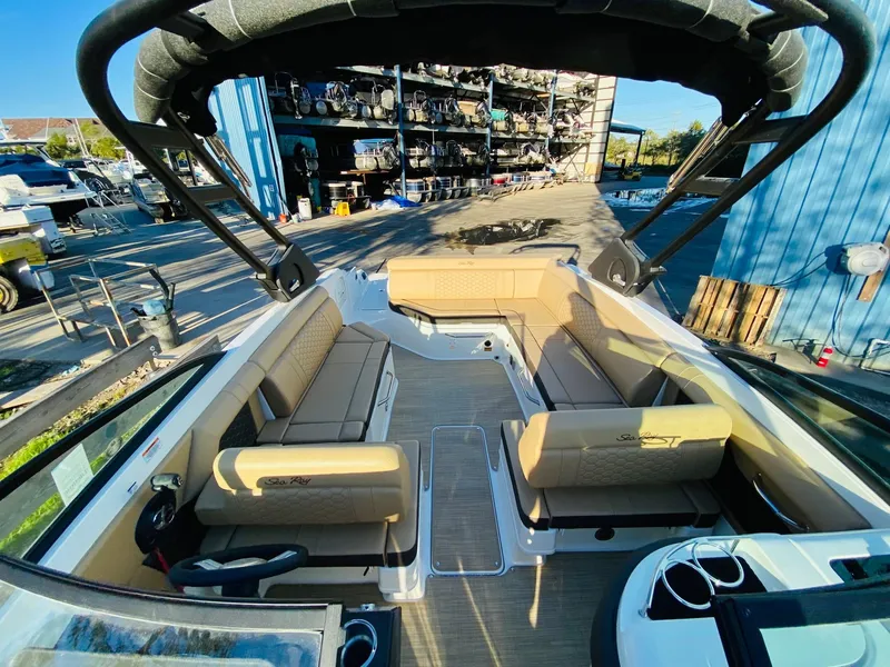 Slide: The Image of 2022 Sea Ray 270 SDX boat interior with tan seating and spacious layout. - 26