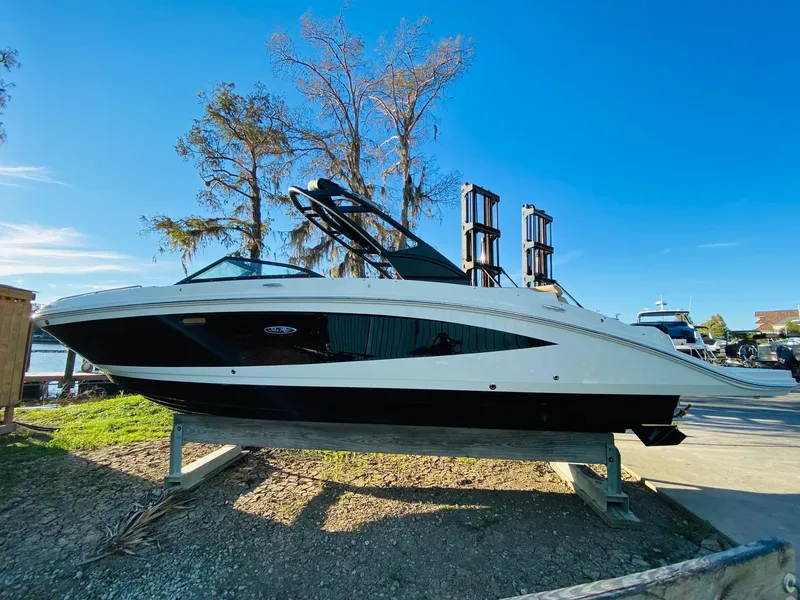 Slide: The Image of 2022 Sea Ray 270 SDX boat on display, side view, outdoors, clear sky. - 6