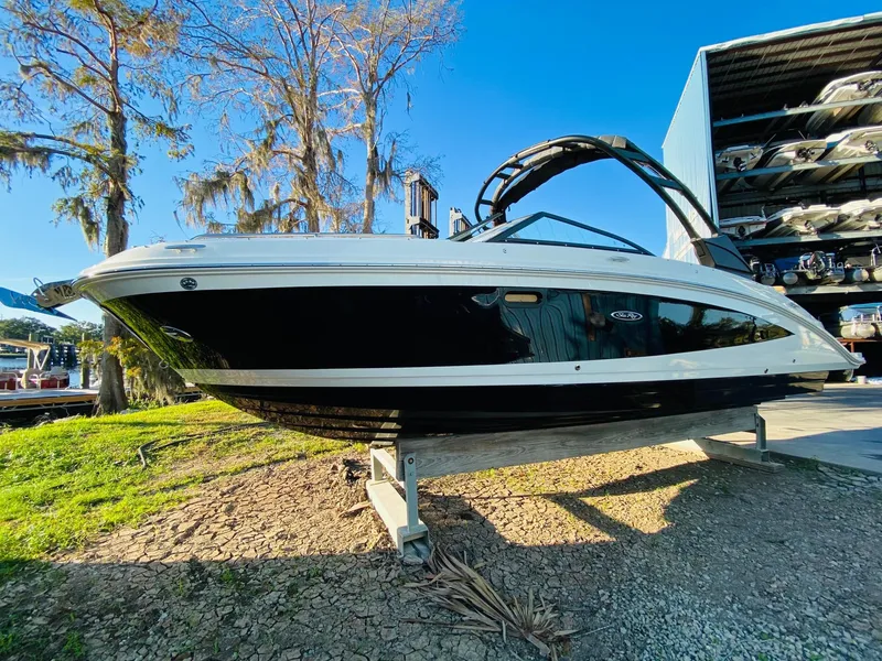 Slide: The Image of 2022 Sea Ray 270 SDX boat on display, black and white exterior, sunny day. - 7