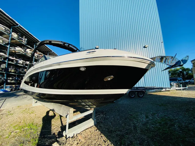Slide: The Image of 2022 Sea Ray 270 SDX boat on display outdoors, with sleek black and white design. - 9