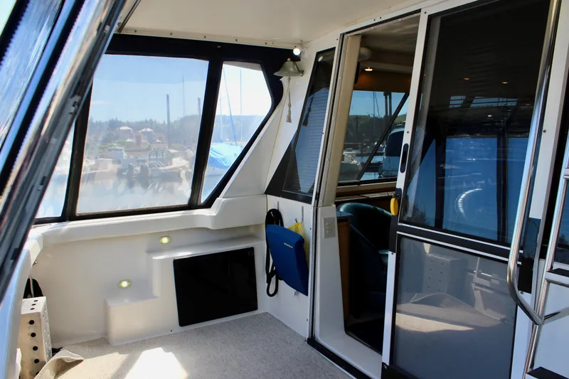 Slide: The Image of 1999 Bayliner 4788 Motoryacht interior with large windows and sliding glass door. - 10