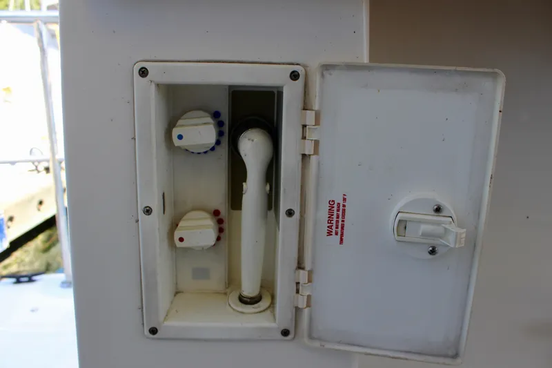 Slide: The Image of 1999 Bayliner 4788 Motoryacht shower controls with temperature knobs and handheld showerhead. - 12