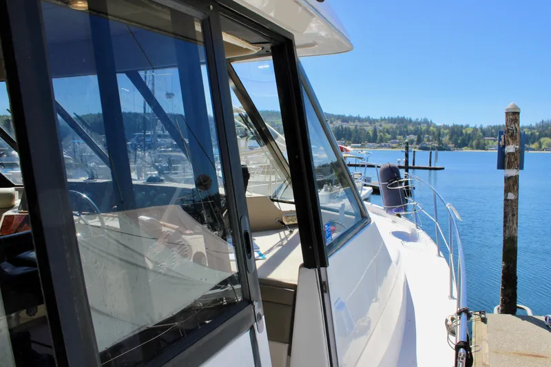 Slide: The Image of 1999 Bayliner 4788 Motoryacht docked at a marina on a sunny day. - 13
