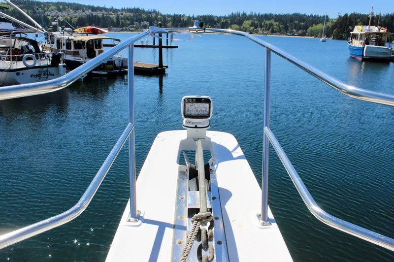 Slide: The Image of Bow view of 1999 Bayliner 4788 Motoryacht on calm water. - 16