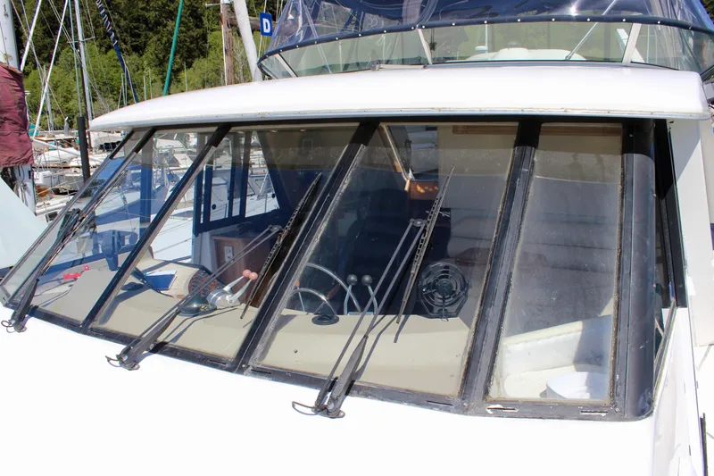 Slide: The Image of 1999 Bayliner 4788 Motoryacht windshield with wipers, docked in a marina. - 20