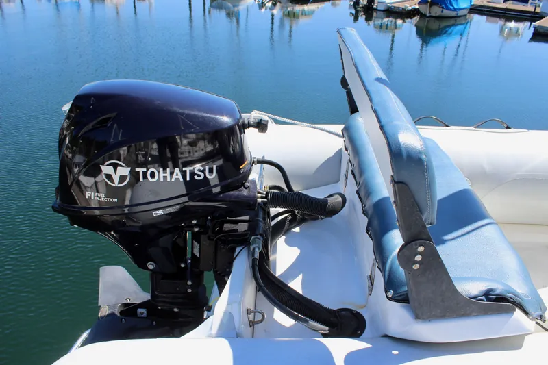 Slide: The Image of Tohatsu outboard motor on 1999 Bayliner 4788 Motoryacht, docked in marina. - 22