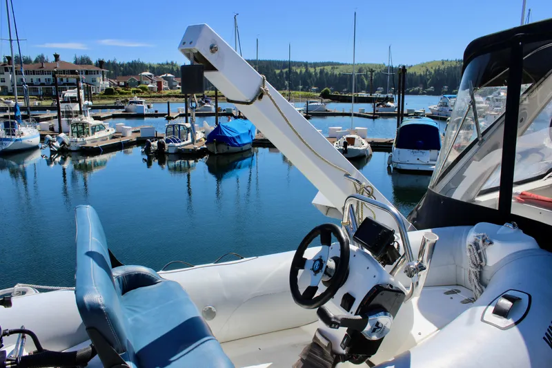 Slide: The Image of 1999 Bayliner 4788 Motoryacht at marina, featuring helm and seating area. - 23