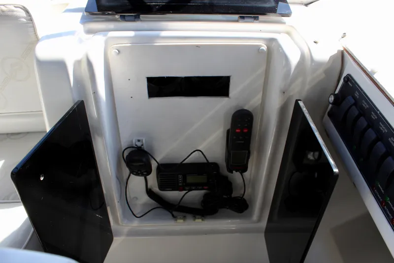 Slide: The Image of 1999 Bayliner 4788 Motoryacht dashboard with communication equipment and controls. - 28