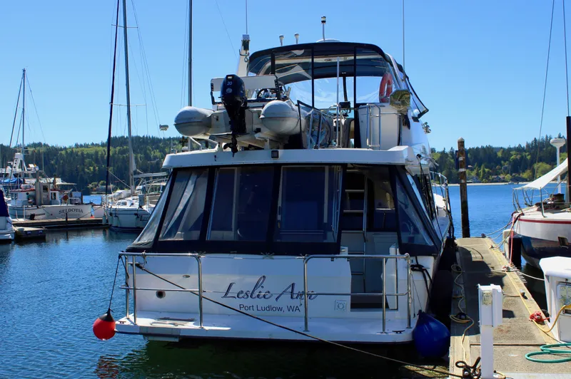 Slide: The Image of 1999 Bayliner 4788 Motoryacht docked at marina, rear view, sunny day. - 3