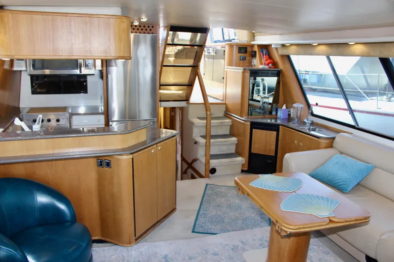 Slide: The Image of Luxurious interior of 1999 Bayliner 4788 Motoryacht with modern kitchen and cozy seating area. - 34