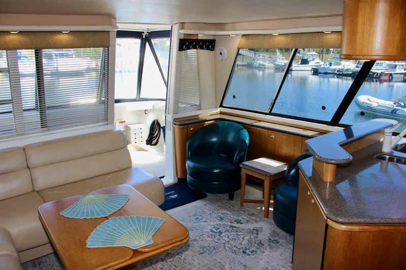 Slide: The Image of Luxurious interior of 1999 Bayliner 4788 Motoryacht with leather seating and waterfront view. - 35
