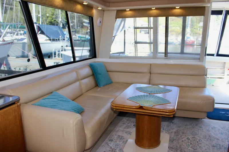 Slide: The Image of Luxurious interior of 1999 Bayliner 4788 Motoryacht with leather seating and wooden table. - 36
