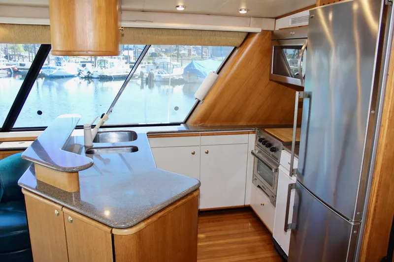 Slide: The Image of 1999 Bayliner 4788 Motoryacht kitchen with modern appliances and waterfront view. - 39