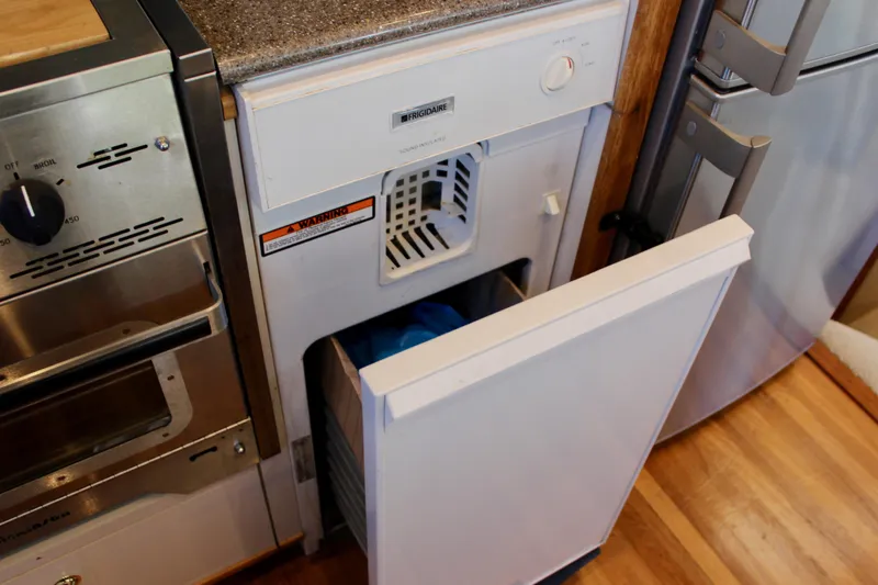 Slide: The Image of Ice maker in 1999 Bayliner 4788 Motoryacht kitchen, with open door and wooden flooring. - 44