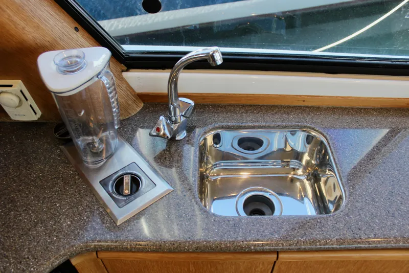 Slide: The Image of 1999 Bayliner 4788 Motoryacht kitchen sink with faucet and blender on countertop. - 46