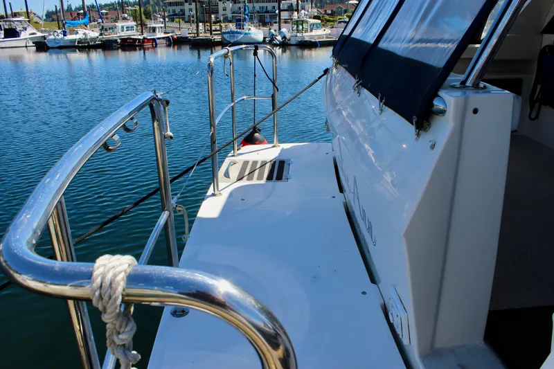 Slide: The Image of 1999 Bayliner 4788 Motoryacht docked at marina, showcasing deck and railing. - 9