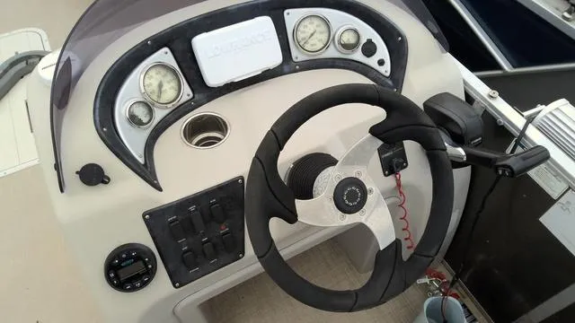 Slide: The Image of 2020 SunCatcher V322 F boat dashboard with steering wheel and gauges. - 4