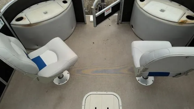 Slide: The Image of 2020 SunCatcher V322 F boat interior with two swivel seats and storage compartments. - 5