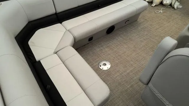 Slide: The Image of 2019 SunCatcher V20 F boat interior with beige seating and carpeted flooring. - 10