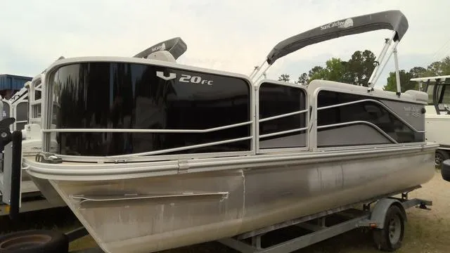Slide: The Image of 2019 SunCatcher V20 F pontoon boat on trailer, featuring sleek design and canopy. - 12