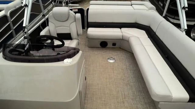 Slide: The Image of 2019 SunCatcher V20 F boat interior with beige seating and steering console. - 4
