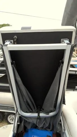 Slide: The Image of 2019 SunCatcher V20 F boat storage compartment with open lid and fabric lining. - 8