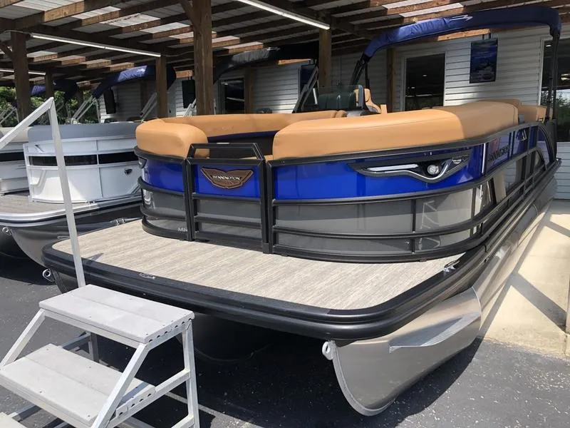 The Image of 2025 Bennington M L-Bench 24ML pontoon boat with tan seating and blue accents. - 1