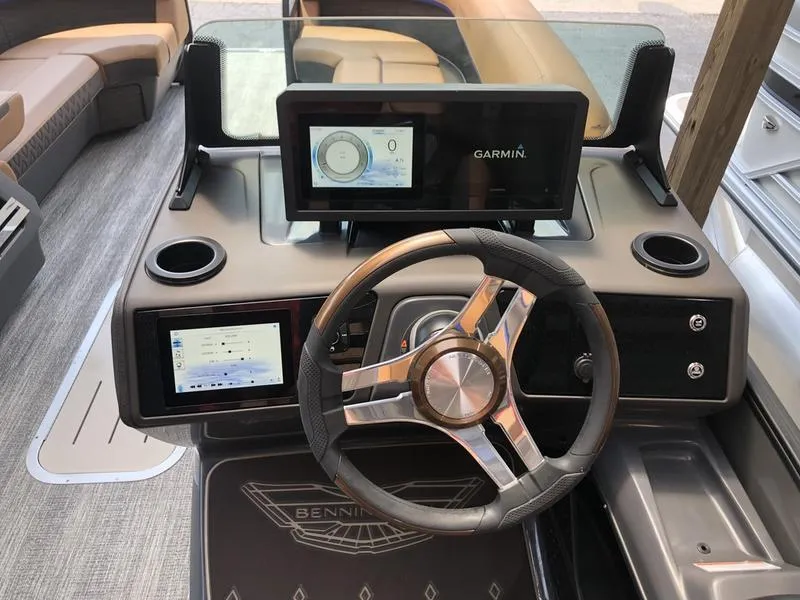 Slide: The Image of 2025 Bennington M L-Bench 24ML boat dashboard with Garmin display and modern steering wheel. - 6