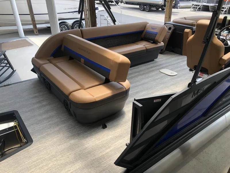 Slide: The Image of 2025 Bennington M L-Bench 24ML pontoon boat interior with tan seating and modern design. - 8