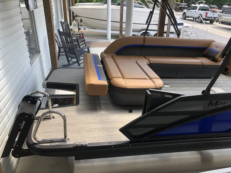 Slide: The Image of 2025 Bennington M L-Bench 24ML pontoon boat with tan seating and sleek design. - 9
