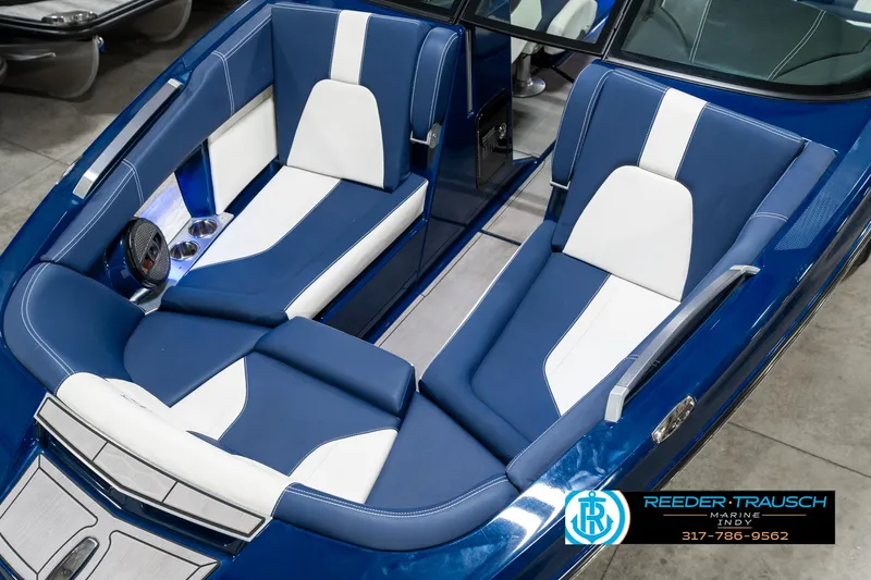 Slide: The Image of 2025 MasterCraft X24 boat interior with blue and white seating, showcasing luxury design. - 12