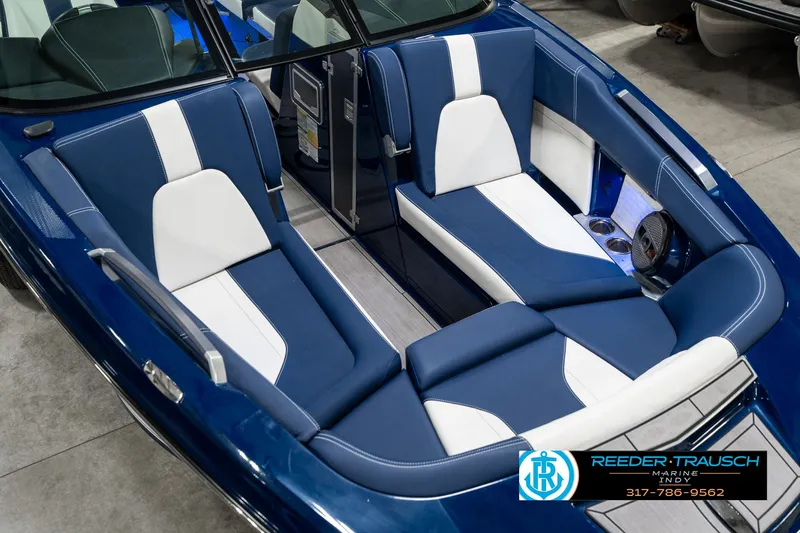Slide: The Image of 2025 MasterCraft X24 boat interior with blue and white seating, showcasing luxury design. - 13