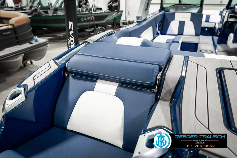 Slide: The Image of 2025 MasterCraft X24 boat interior with blue and white seating, showcasing luxury design. - 36