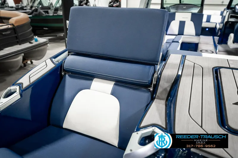Slide: The Image of 2025 MasterCraft X24 boat interior with blue and white seating, featuring sleek design elements. - 37